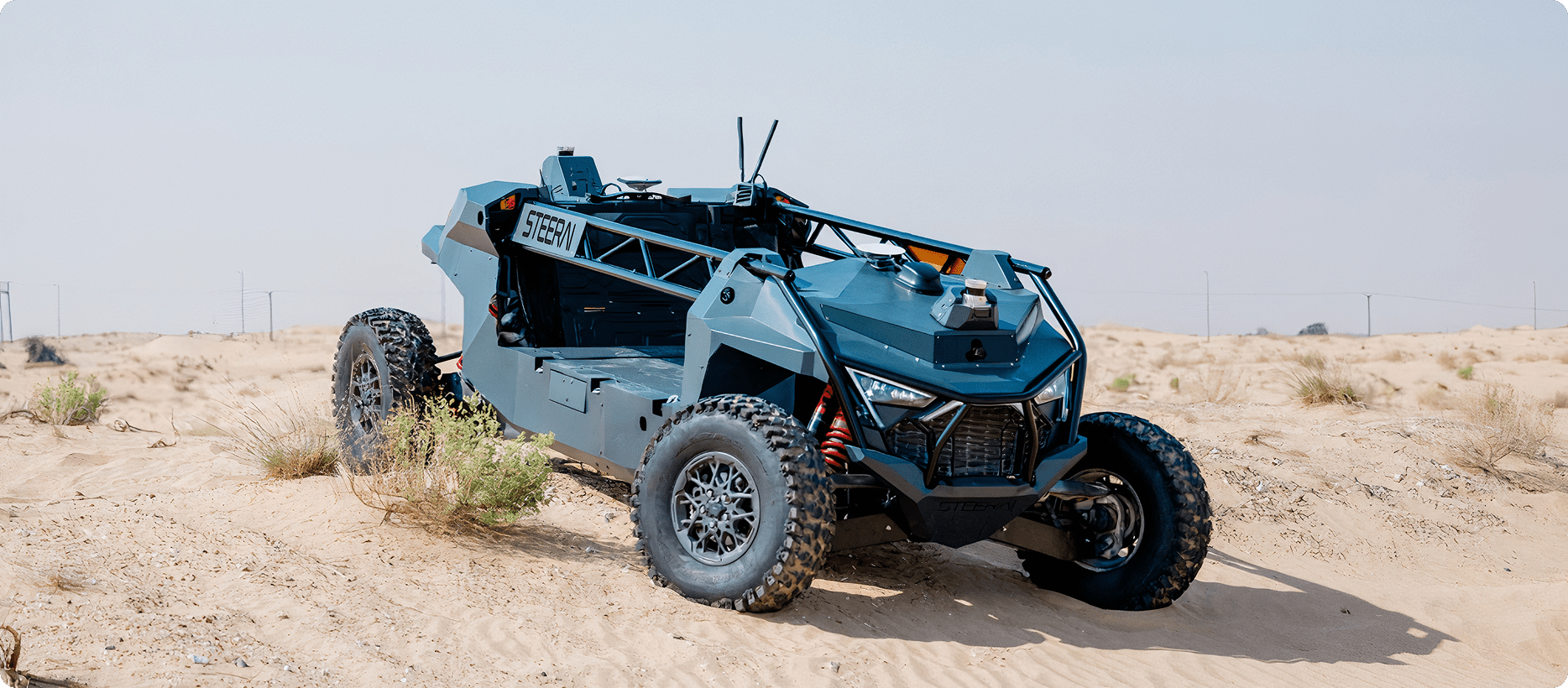 An xRift drives through a vast desert landscape under a clear blue sky.