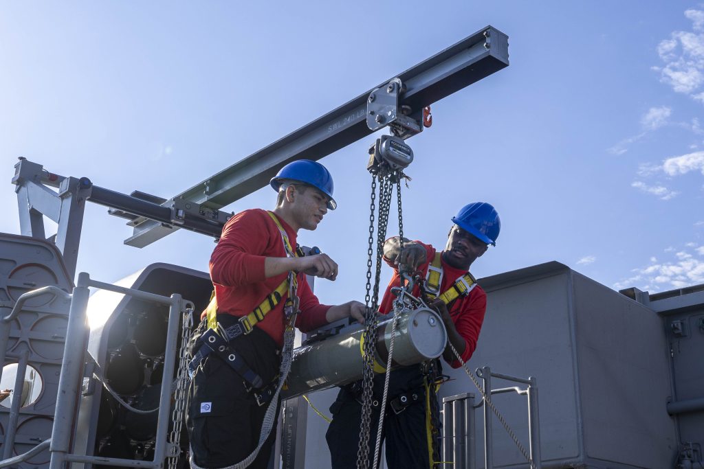 a RIM-116 Rolling Airframe Missile (RAM) being loaded for a live fire exercise