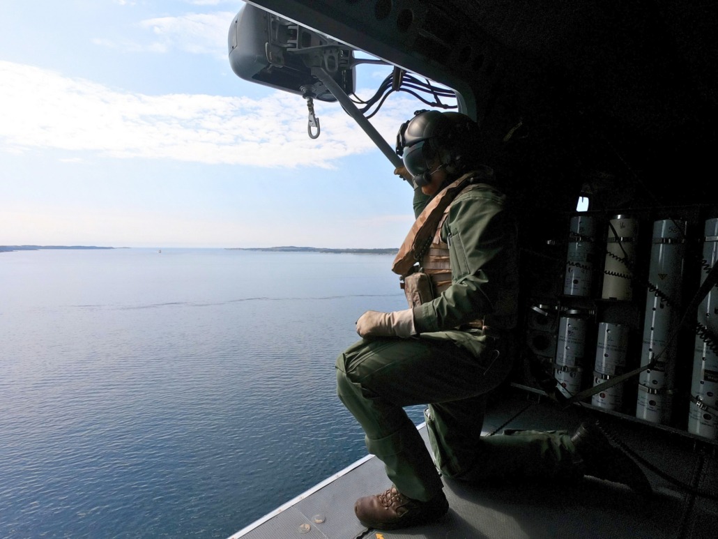 UK Royal Navy crewmember drops sonobouys into the sea
