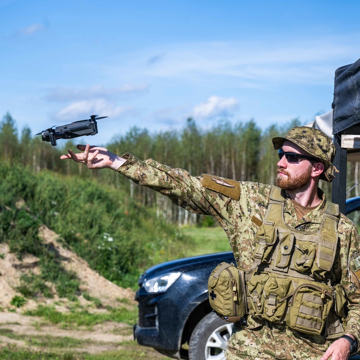 Personnel deploying a small unmanned aerial system