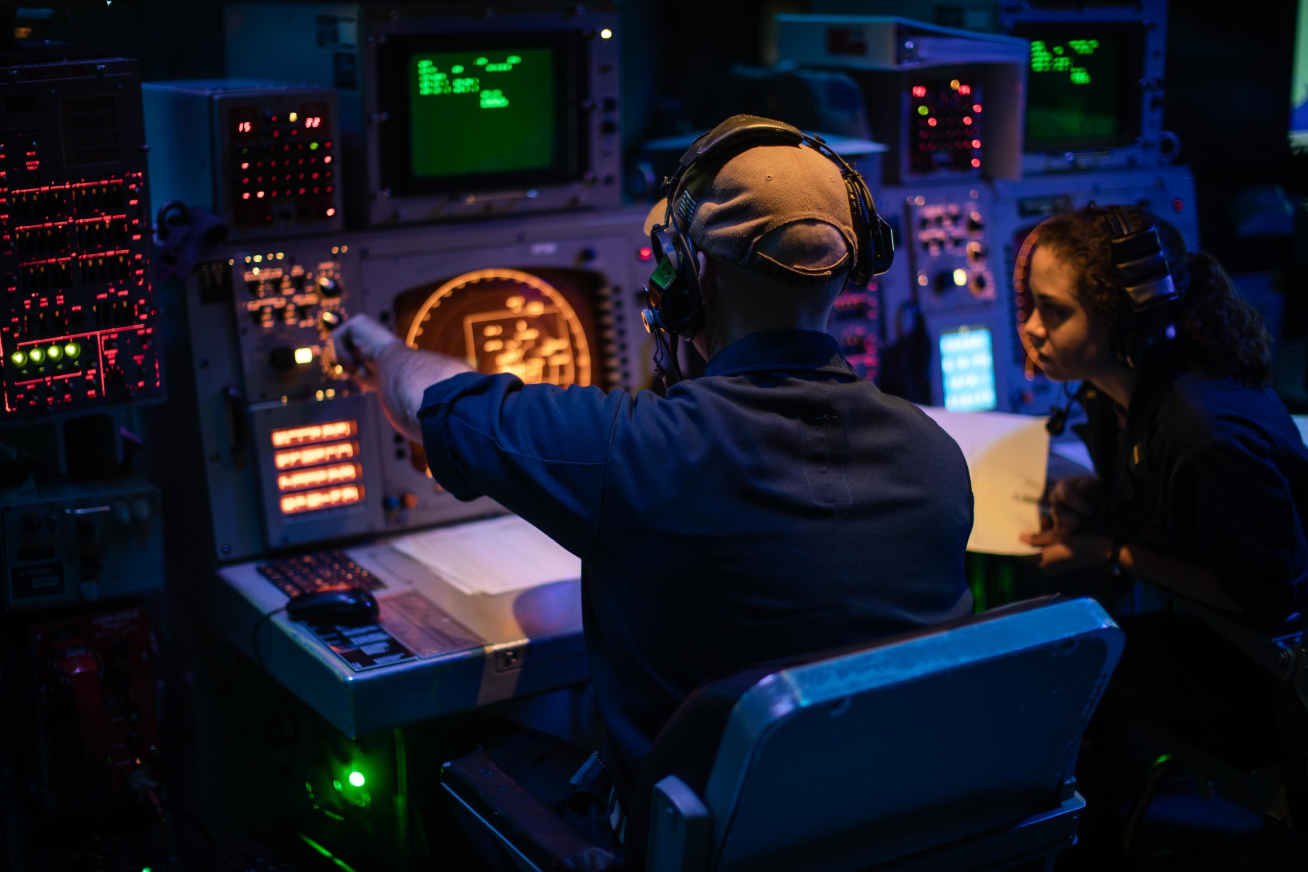 210803-N-TP544-2022 ATLANTIC OCEAN (Aug. 3, 2021) Chief Operations Specialist Mark Chaisson teaches Ensign Elizabeth Herington how to use a radar console aboard the Wasp-class amphibious assault ship USS Kearsarge (LHD 3) August 3, 2021. Kearsarge is underway to support Large-Scale Exercise 2021 (LSE 2021), a globally integrated exercise designed to test advanced warfare concepts across the full-range of maritime and amphibious operations under Distributed Maritime Operations (DMO). LSE 2021 will take place Aug. 3-16, 2021, in the U.S. Pacific Fleet, U.S. Fleet Forces, and U.S. Naval Forces Europe areas of operation, as well as virtually. (U.S. Navy photo by Mass Communication Specialist Seaman Taylor Parker)