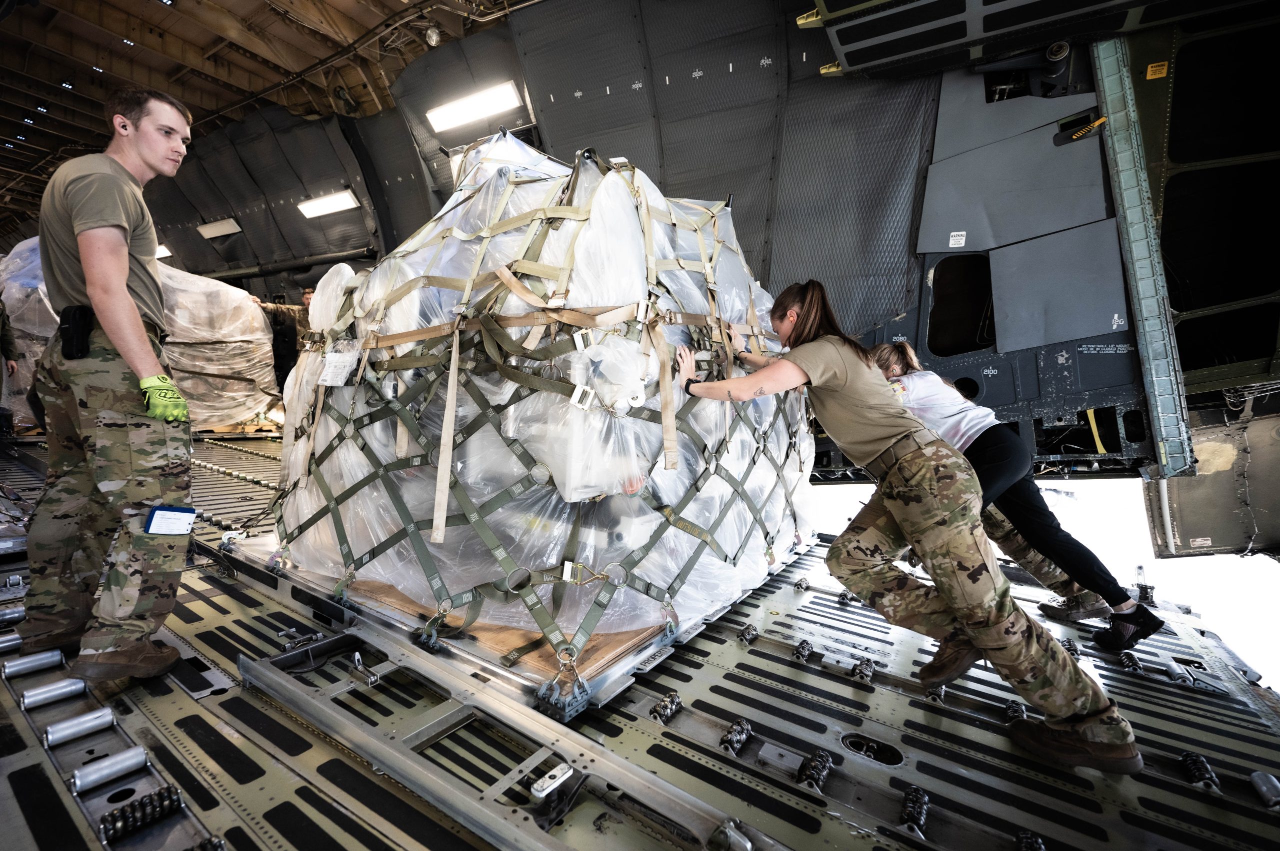 Senior Airman Jenna Hayes, a loadmaster assigned to the 709th Airlift Squadron, and Taylor Kastenhuber, a traffic management office contractor with Criterion East, push a pallet of medical supplies bound for Honduras at Pittsburgh International Airport Air Reserve Station on Nov. 6, 2024. In total 32 pallets totaling nearly 8,000 pounds of cargo were transported in support of the Denton Program. (U.S. Air Force photo taken by Master Sgt. Jeffrey Grossi)