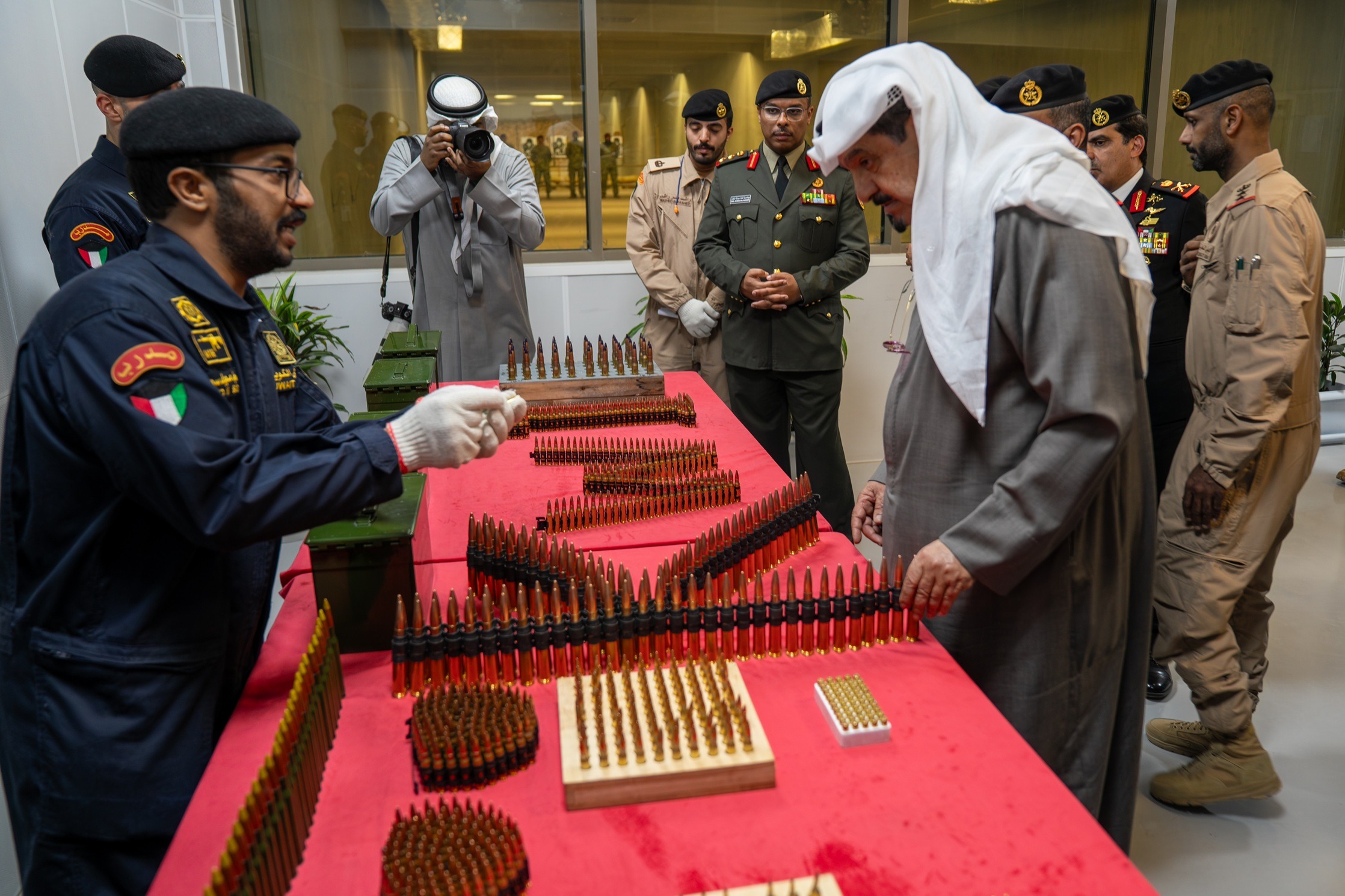 Kuwait's Prime Minister Sheikh Ahmad Abdullah Al-Ahmad Al-Sabah inspecting shells at a new ammunitions factory