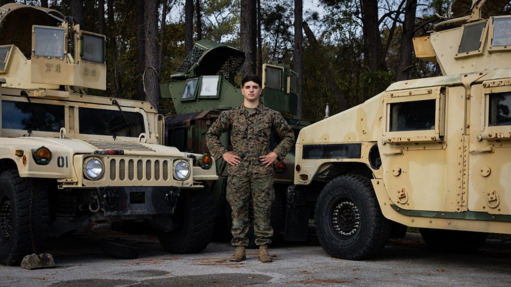 three M1151A1 High Mobility Multipurpose Wheeled Vehicles on Marine Corps Base