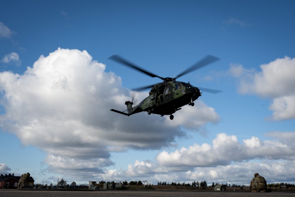 Forward Area Refueling Point operators from the 100th Air Refueling Wing prepare to conduct a FARP on a Finnish NH90 transport helicopter during Exercise Florin Fossil at Utti Jaeger Regiment Base