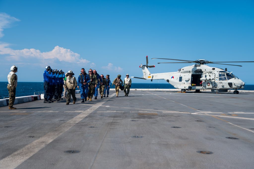 A Royal Netherlands Navy NH90 helicopter being signaled to hover above New York’s flight deck.