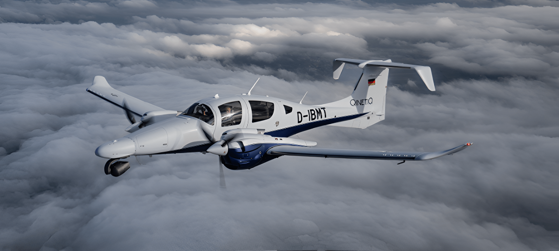 A twin-engine multi-mission aircraft operated by QinetiQ flying above cloud cover, configured for surveillance, test, and intelligence-gathering roles.