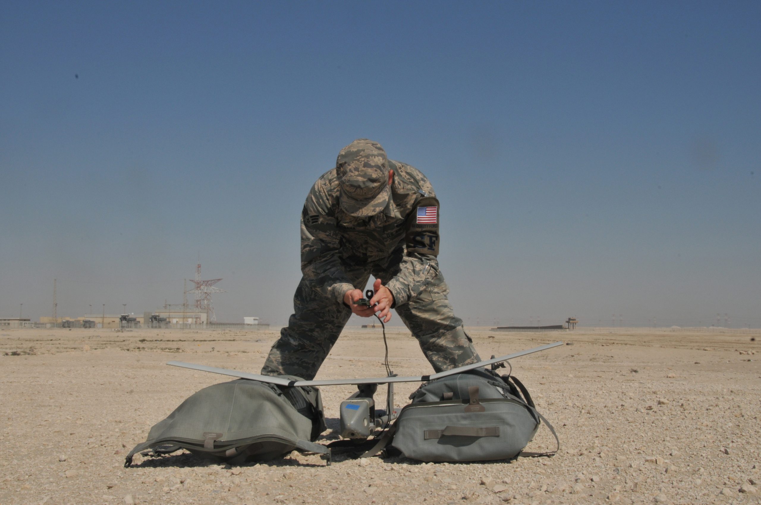 Senior Airman James McGaha, 379th Expeditionary Security Force Squadron patrolman, prepares the Raven B Digital Data Link drone, a small unmanned aircraft or drone, for flight Feb. 19 at Al Udeid Air Base, Qatar. McGaha checks the drone’s wires and connections to ensure components are operational before flight. (U.S. Air Force photo by Tech. Sgt. Terrica Y. Jones/Released)
