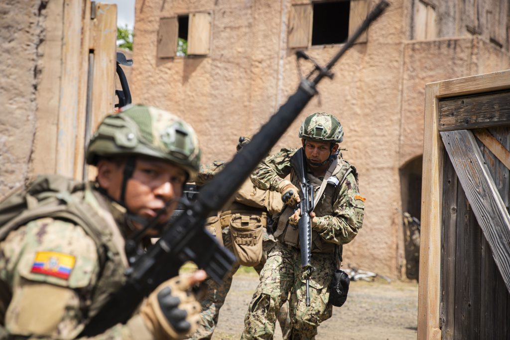 Ecuadorian Naval Infantry Corps marines and U.S. Marines assigned to Bravo Company, Battalion Landing Team 1/5, 15th Marine Expeditionary Unit, egress from the infantry immersion trainer upon completion at Marine Corps Training Area Bellows, Waimanalo, Hawaii, during Exercise Rim of the Pacific (RIMPAC) 2024, July 3. Twenty-nine nations, 40 surface ships, three submarines, 14 national land forces, more than 150 aircraft and 25,000 personnel are participating in RIMPAC in and around the Hawaiian Islands, June 27 to Aug. 1. The world's largest international maritime exercise, RIMPAC provides a unique training opportunity while fostering and sustaining cooperative relationships among participants critical to ensuring the safety of sea lanes and security on the world's oceans. RIMPAC 2024 is the 29th exercise in the series that began in 1971. (U.S. Marine Corps photo by Cpl. Luis Agostini)