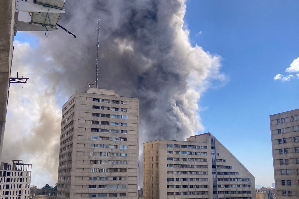 Plumes of smoke rise following reported explosions in Tehran on March 1, 2026, after Iran's supreme leader, Ayatollah Ali Khamenei, was killed a day earlier in a large US and Israeli attack, prompting a new wave of retaliatory missile strikes from Iran.