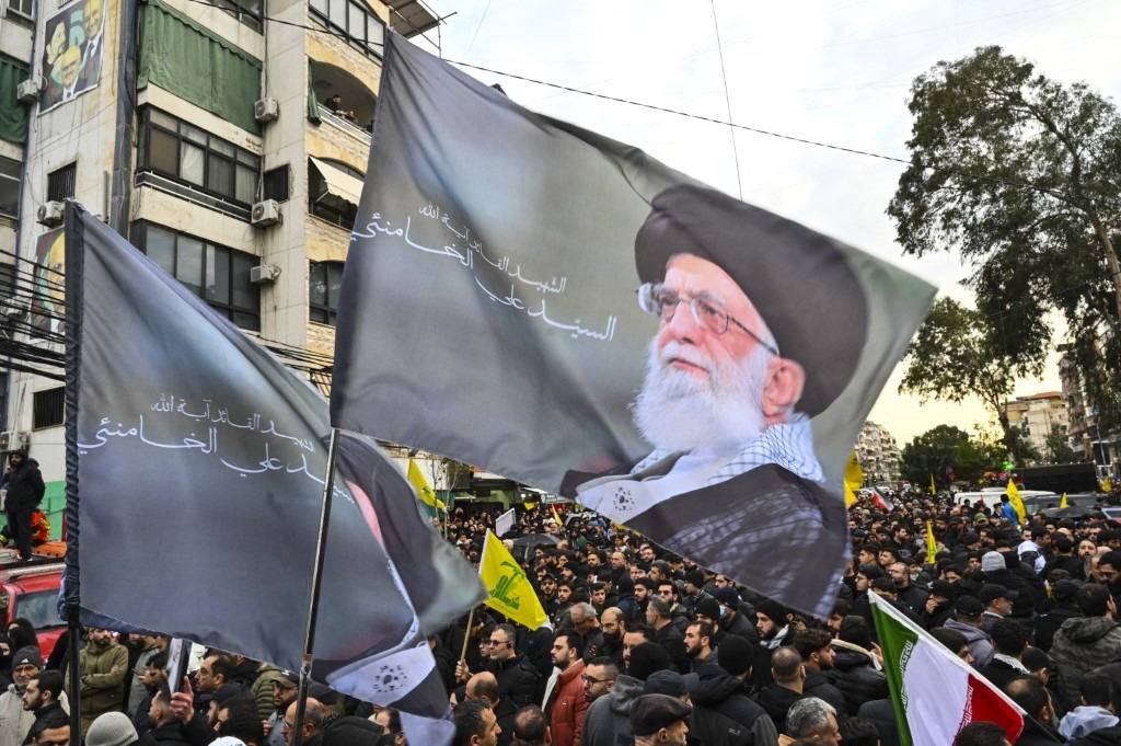 People hold picture of Iran's former Supreme Leader, Ayatollah Ali Khamenei, while crying at an event honoring Iran's former Supreme Leader, Ayatollah Ali Khamenei, on March 1, 2026 at Ashoura Square in southern Beirut, Lebanon.