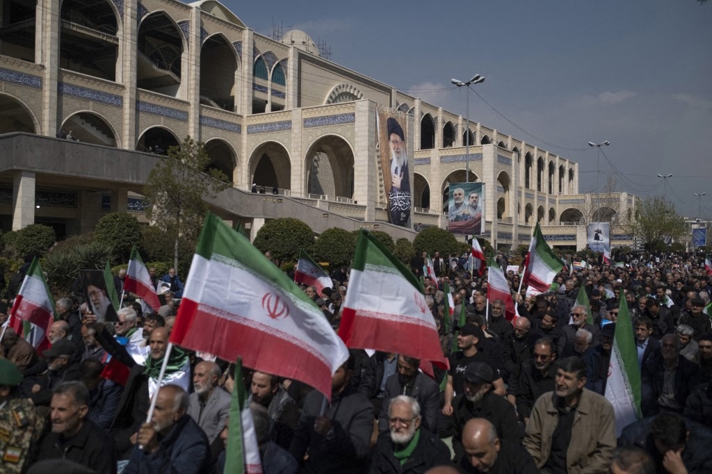 Iranian worshippers hold national flags and participate in Tehran's Friday prayers at Imam Khomeini Grand Mosque in Tehran, Iran, on March 6, 2026.