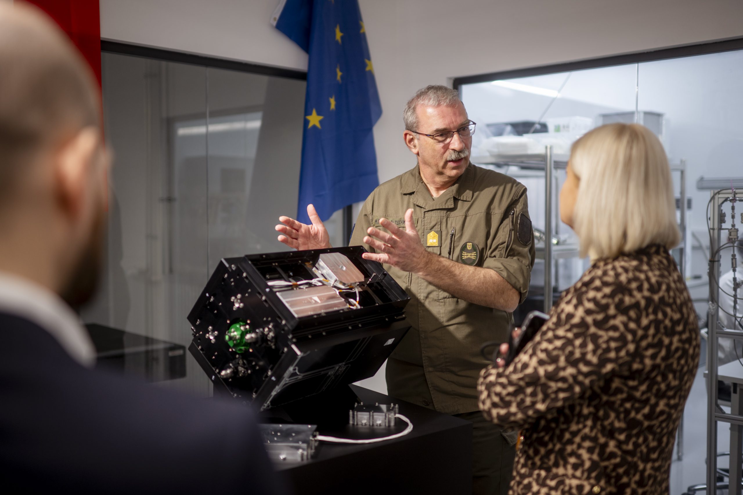Austria Defence Minister Klaudia Tanner takes a look at a critical component of her country's first military satellite.