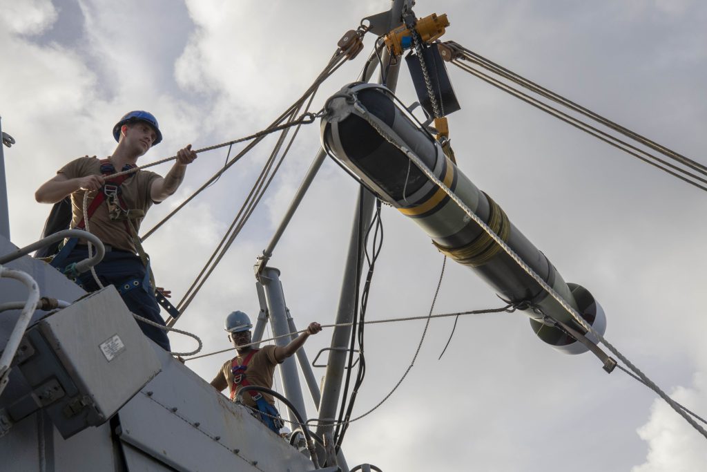 MK 54 Lightweight Torpedo hoisted onto the aft missile bay from the flight deck of the Arleigh Burke-class guided-missile destroyer USS Spruance