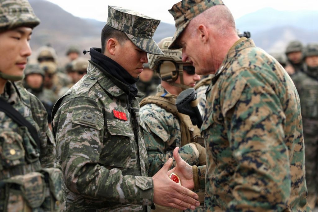Republic of Korea Marine Corps Staff Sgt. Kim receives a challenge coin during exercise Freedom Shield 26