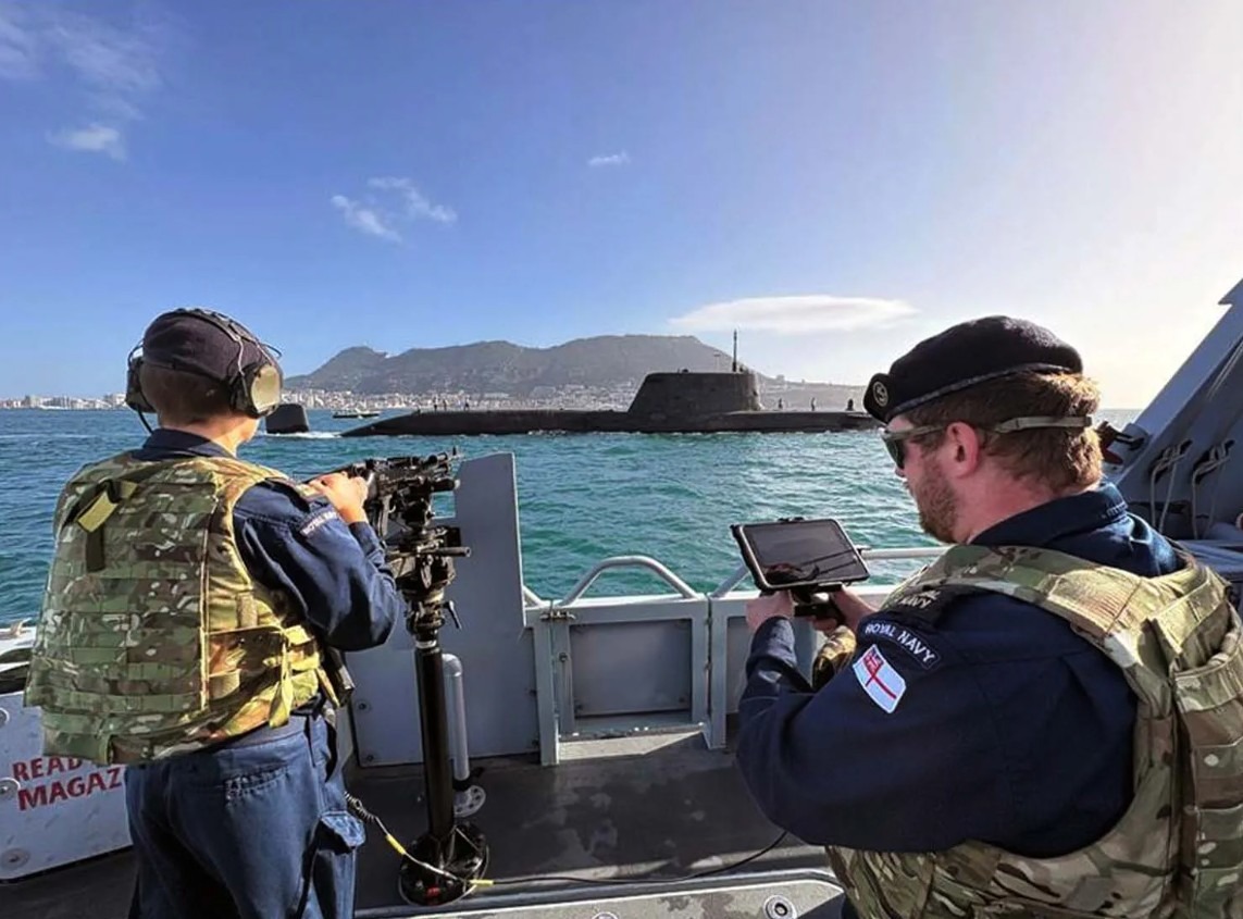 UK Royal Navy troops operating a drone.