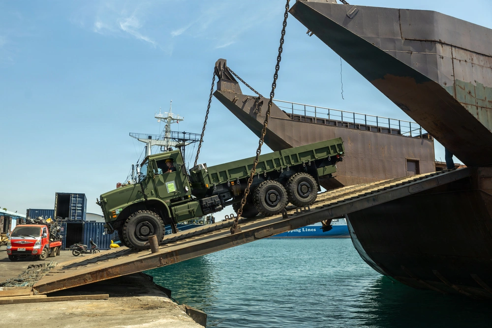 US Marines and Philippine contractors load a Medium Tactical Vehicle Replacement onto a barge in Cagayan de Oro, Philippines in support of Exercise Balikatan 2026.