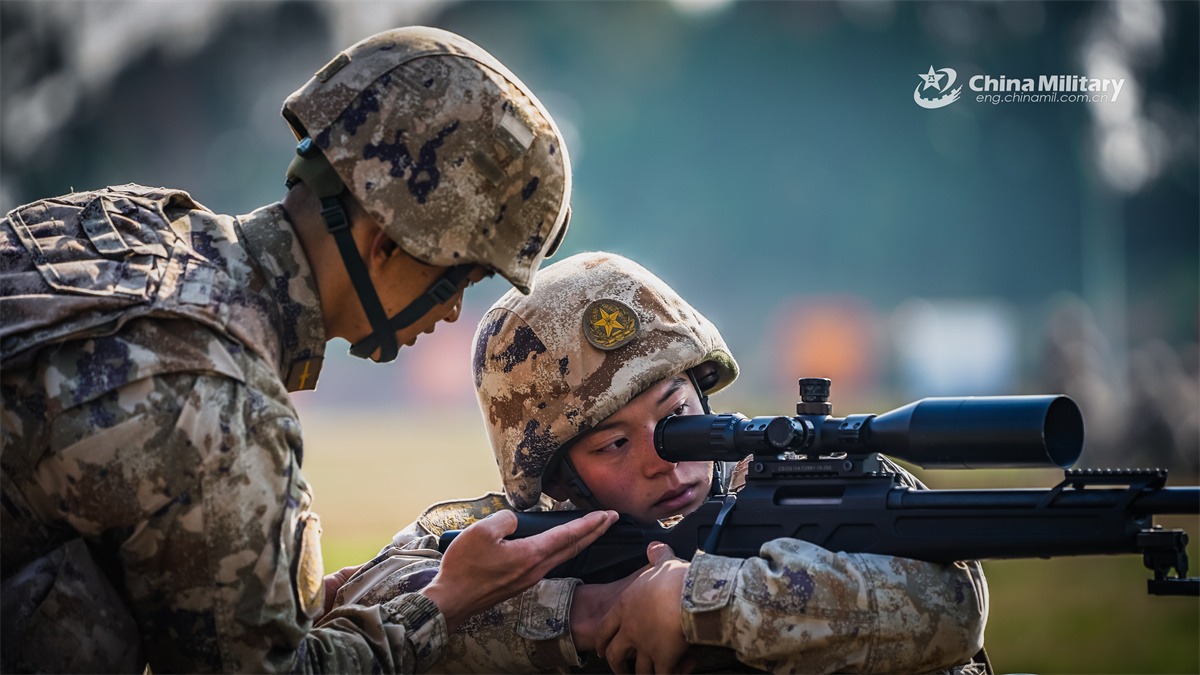 A sniper assigned to a brigade under the Chinese PLA Western Theater Command practice aiming and positioning with a CS/LR4 sniper rifle during a sniper training session.