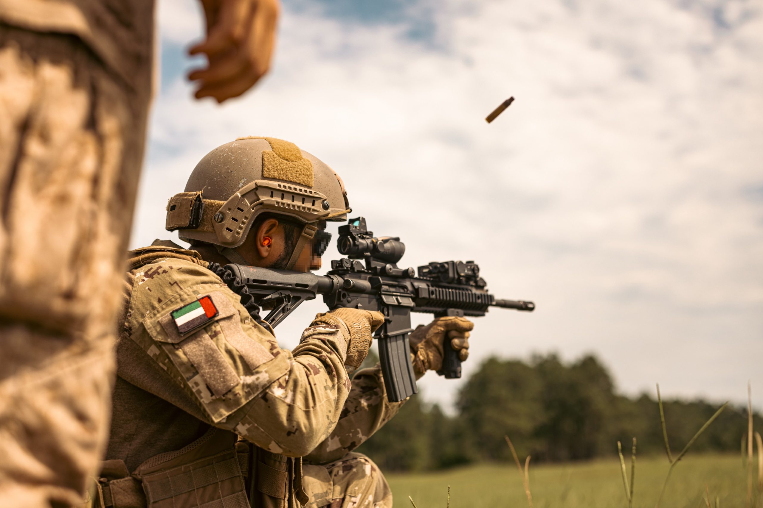 A United Arab Emirates soldier with the Al Forsan Brigade, Presidential Guard fires a CAR 816/Sultan during a Unit Enhancement Training 24-2 event on Marine Corps Base Camp Lejeune, North Carolina, July 18, 2024. The UET 24-2 consisted of a series of combined arms offensive and counter-insurgency operations at the platoon level, enhancing the proficiency, tactical readiness, and interoperability between the Marine Corps and foreign partners. (U.S. Marine Corps photo by Cpl. Antonino Mazzamuto) (This photo has been altered for security purposes.)