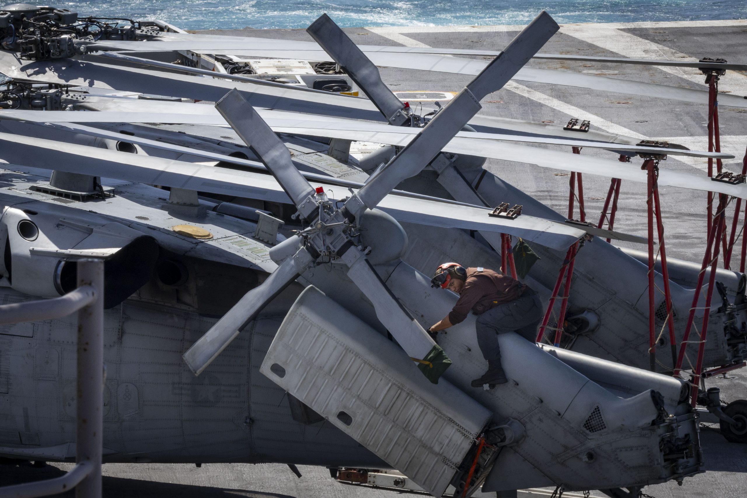 250812-N-NQ605-1055 ATLANTIC OCEAN (Aug. 12, 2025) Aviation Electronics Technician Airman Zurial Jones, assigned to the “Nightdippers” of Helicopter Sea Combat Squadron (HSC) 5, performs maintenance on an MH-60S Sea Hawk helicopter aboard the Nimitz-class aircraft carrier USS George H.W. Bush (CVN 77). George H.W. Bush is underway conducting carrier qualifications and routine operations in the Atlantic Ocean. (U.S. Navy photo by Mass Communication Specialist 2nd Class Ceszar Villalbabaldonado)