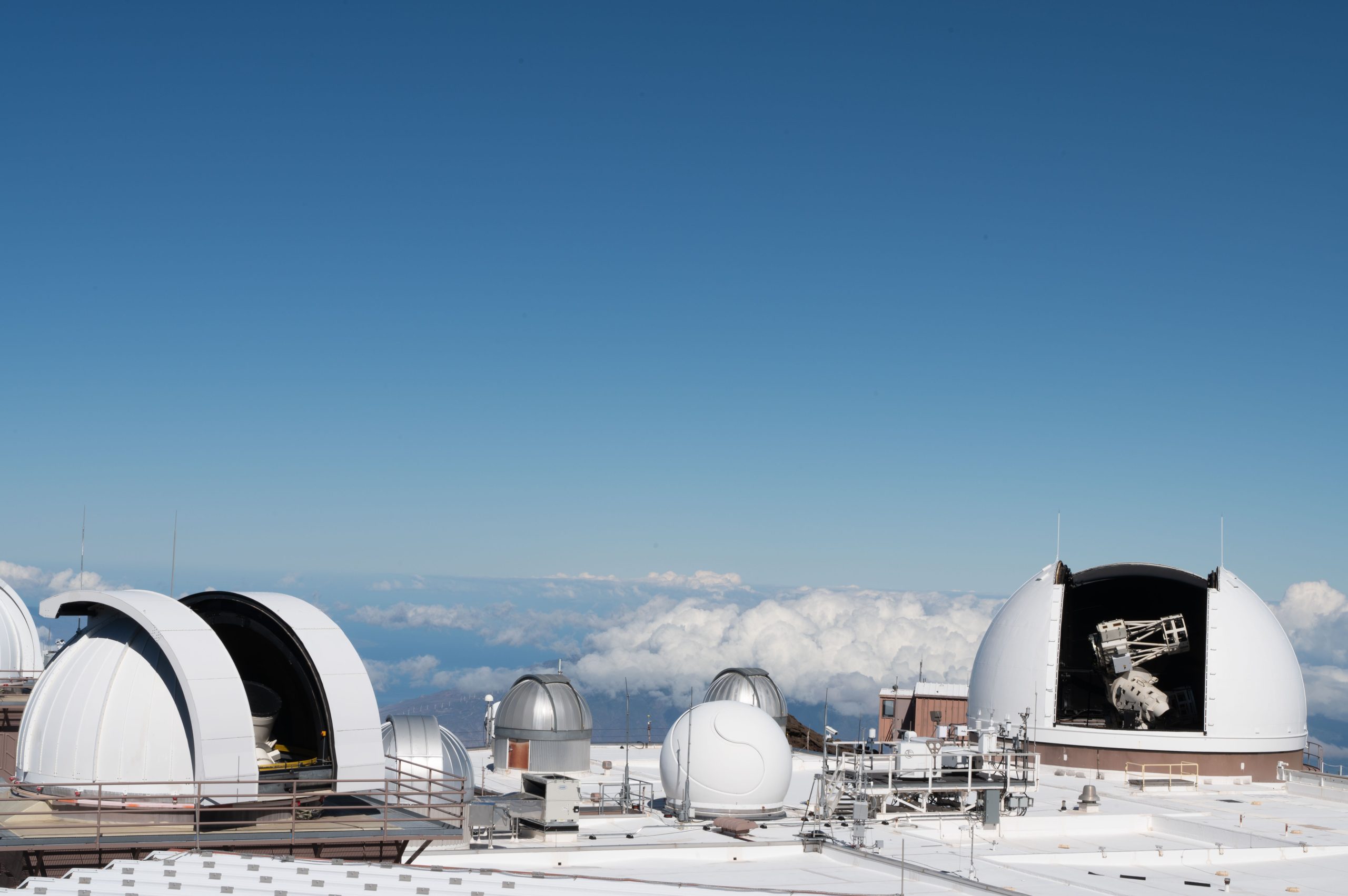 Telescopes operated by the 15th Space Surveillance Squadron at the Maui Space Surveillance Complex are shown on Maui, Hawaii, Sept. 16, 2025. The MSSC is located on Haleakala, is the third best place on Earth from which to view space, and the best location for daytime space domain awareness. GBOSS upgrades to the legacy Ground Based Electro-Optical Deep Space Surveillance System at the White Sands Missile Range were completed and reached operational acceptance on June 27, 2025, and the upgrades to the MSSC in Hawaii are currently underway. The GBOSS system was built to continue to meet the Space Surveillance Network mission needs and to increase SDA by more accurately identifying and tracking resident space objects in orbit. Chief of Space Operations Gen. Chance Saltzman noted, “GBOSS improves our ability to map the space operating environment. The upgrade not only improves sensitivity and boosts the number of objects we can track, it also takes advantage of data provided by commercial sensors to help with our unquenchable thirst for more SDA data.” (U.S. Air Force photo by 1st Lt. Laura Anderson)