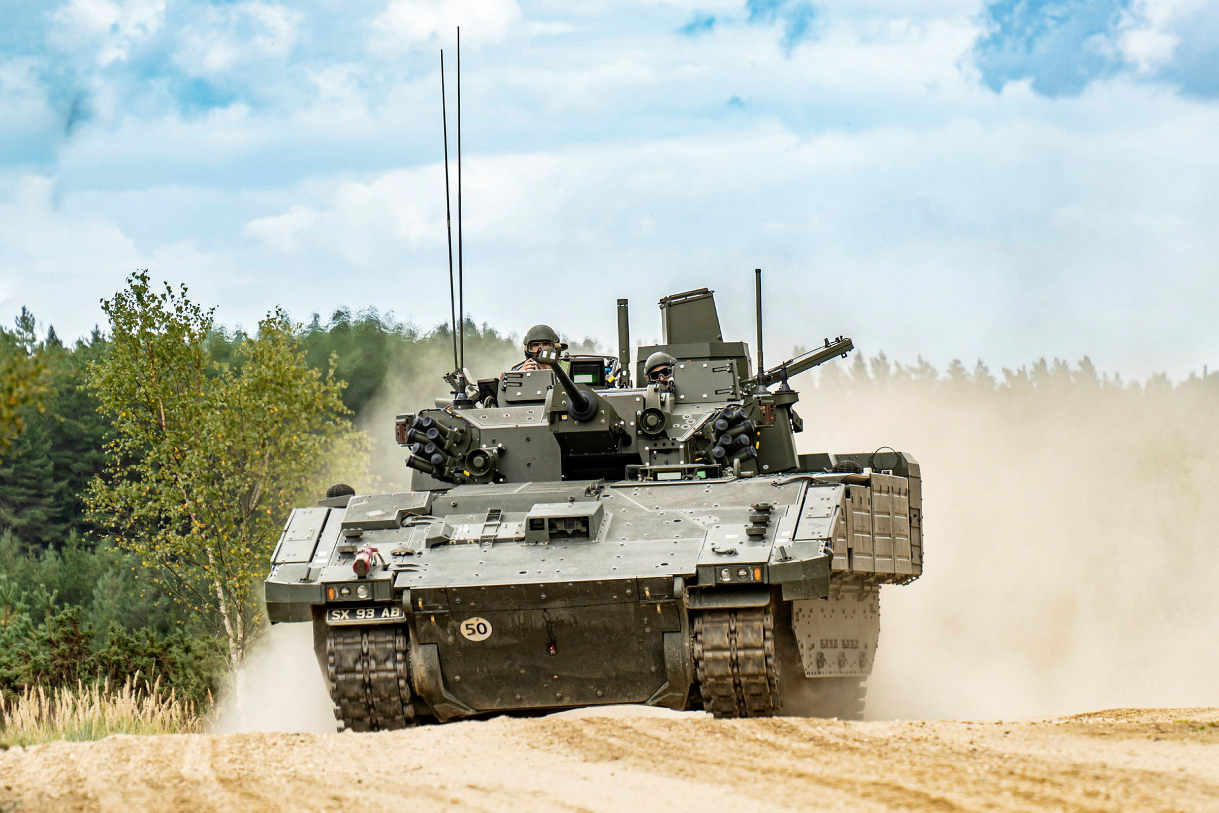 Pictured: AJAX Armoured Fighting Vehicle being tested at the Armoured Trials and Development Unit (ATDU) facility at Bovington. Ajax is an advanced, fully digitised, land vehicle system delivering transformational change in capability to the British Army. There are six variants in the Ajax family, all based upon a common base platform. The Ajax family has been designed to be at the heart of the British Army’s future armoured fleet, offering enhanced lethality, survivability, reliability, mobility and all-weather intelligence, surveillance, target acquisition and reconnaissance (ISTAR) capabilities through its advanced sensor suite. Ajax is currently in the Demonstration and Manufacture phases of its lifecycle. The Army has been conducting training on early Ajax vehicles in both operational Units and Training establishments, with Reliability Growth Trials progressing well. Operationally deployable platforms will be delivered to the Field Army throughout 2024, with the Household Cavalry Regiment being the first Army unit to convert to Ajax.
