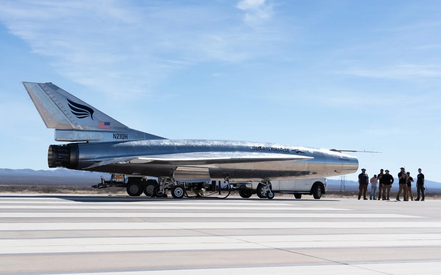 Quarterhorse unmanned test aircraft on a desert runway with ground crew, advancing development as the fastest unmanned aircraft for American warfighters