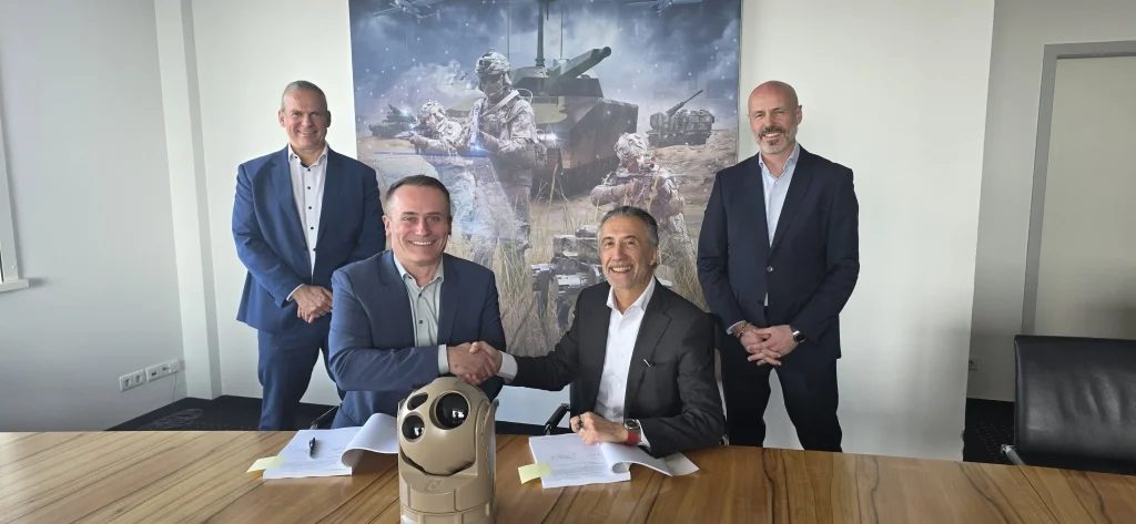 Rheinmetall and Theon officials with a Phylax system. 