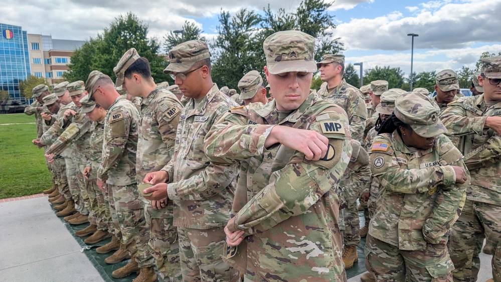 Soldiers assigned to the US Army Training and Doctrine Command replace TRADOC shoulder sleeve insignia with new T2COM patches during a ceremony at Fort Eustis in October 2025.