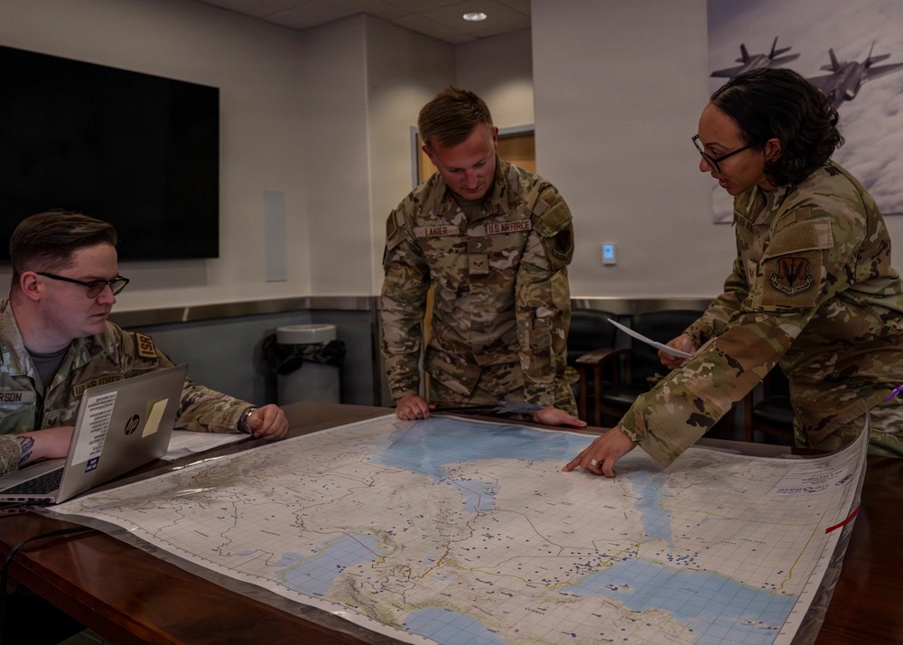 U.S. Air Force Staff Sgt. Seth Larson, a targeting analyst assigned to the 932 Battle Management Control Squadron, Senior Airman James Lanier, a targeting analyst assigned to the 388 Operations Support Squadron, and Staff Sgt. Nitzia Walden-Howard, an intelligence analyst assigned to the 388 OSS, pose for a photo at Hill Air Force Base, UT, 23 April, 2026. The 388th OSS integrates multiple specialties that support mission planning, intelligence, and operations to ensure the 388th Fighter Wing’s combat effectiveness. (U.S. Air Force photo by Staff Sgt. Nicholas Rupiper)