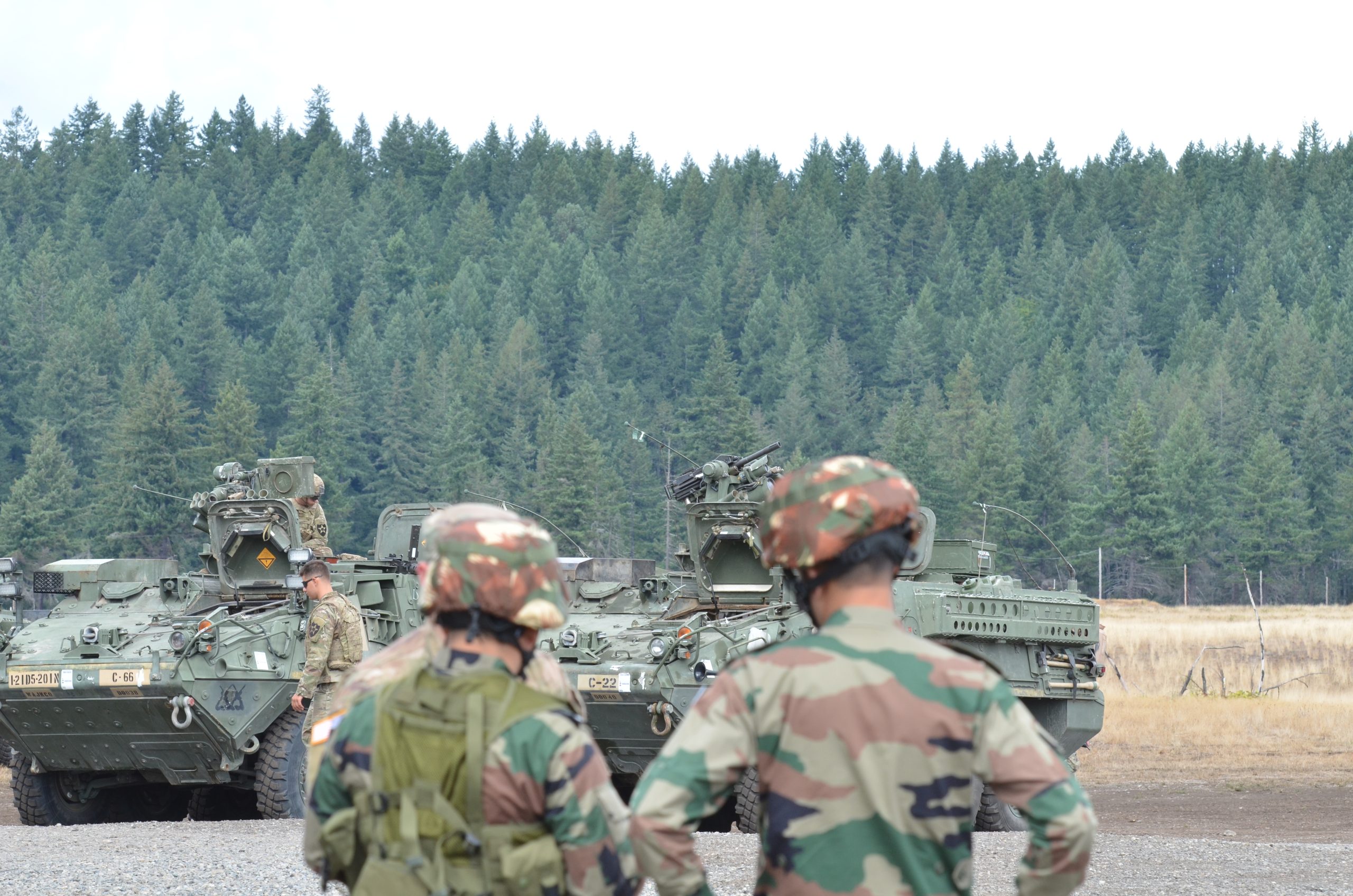 U.S. Army Soldiers from 1-2 Stryker Brigade Combat Team and Indian Army Soldiers examine a Stryker vehicle during exercise Yudh Abhyas 19 at Joint Base Lewis-McChord. (U.S. Army photo by Staff Sgt. Joseph Tolliver, 1-2 Stryker Brigade Combat Team.)