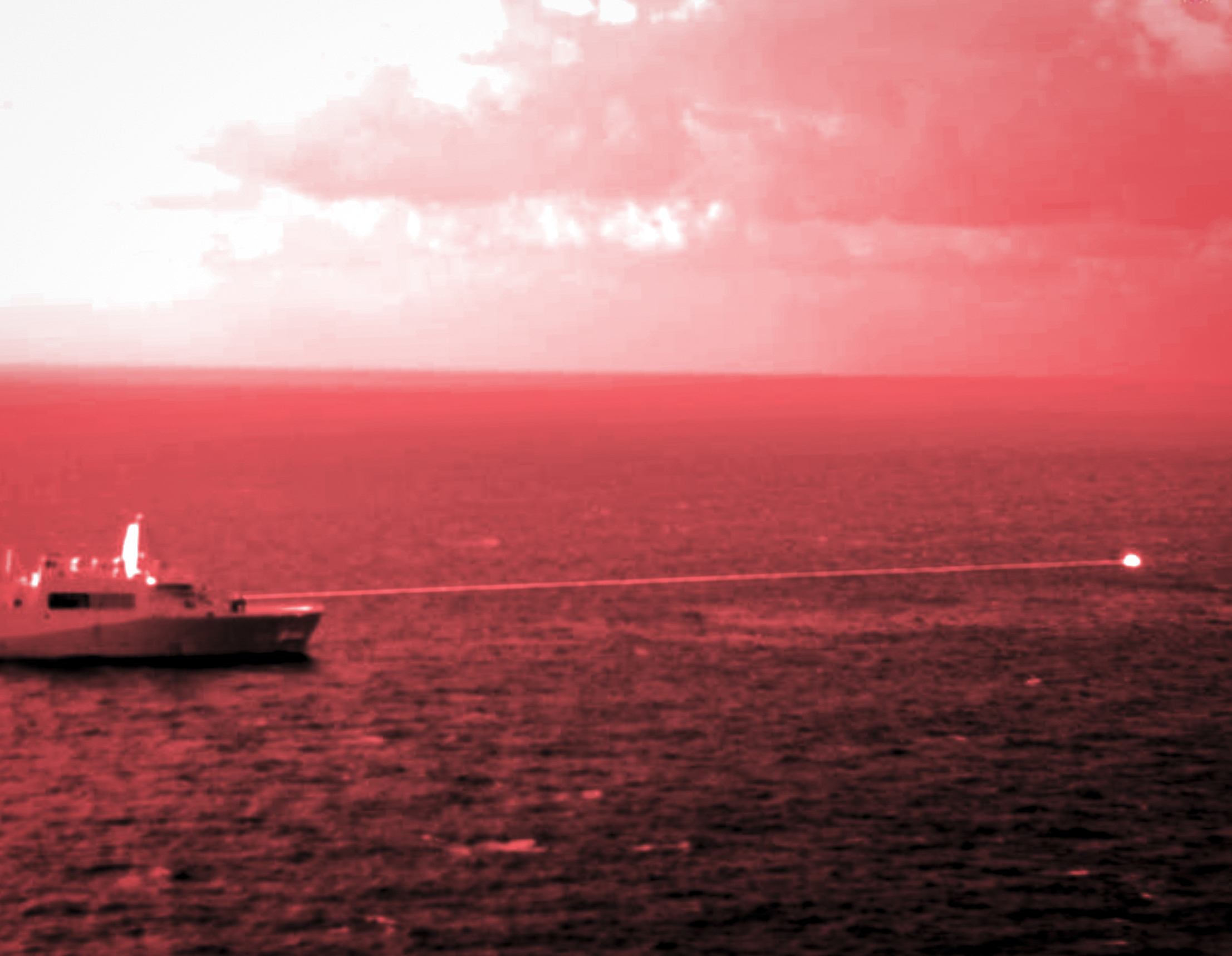 211214-M-HB658-1322 GULF OF ADEN (Dec. 14, 2021) Amphibious transport dock ship USS Portland (LPD 27) conducts a high-energy laser weapon system demonstration on a static surface training target, Dec. 14, while sailing in the Gulf of Aden. During the demonstration, the Solid State Laser – Technology Maturation Laser Weapons System Demonstrator Mark 2 MOD 0 aboard Portland successfully engaged the training target. The photograph was captured utilizing a short wave infrared lens and optical filter. (U.S. Marine Corps photo by Staff Sgt. Donald Holbert)