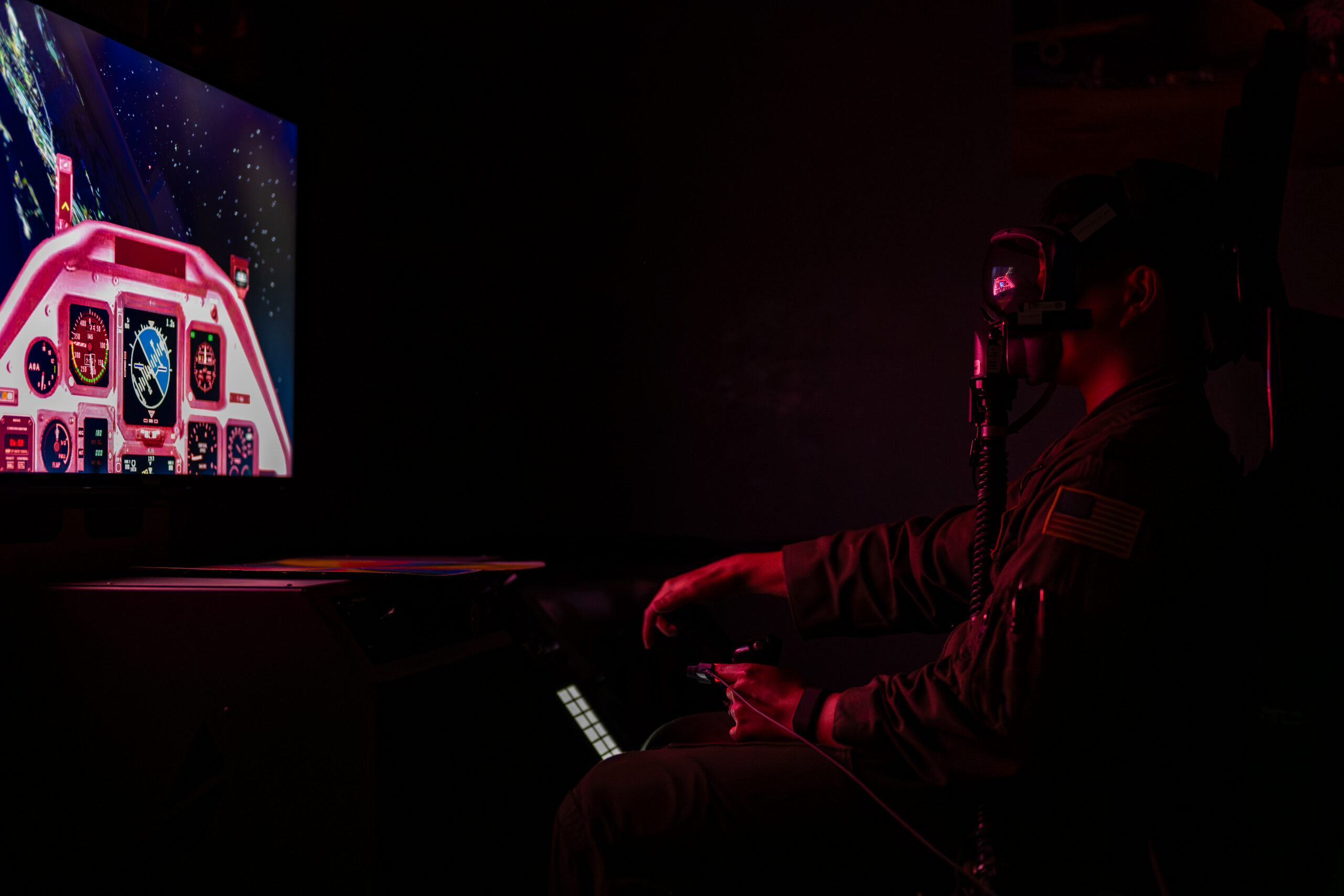 U.S. Air Force Capt. Justin Kong, 312th Airlift Squadron pilot, operates a Hypoxia Familiarization Trainer (HFT) while wearing a quick don mask during aerospace physiology training at Travis Air Force Base, California, Sept. 9, 2025. An HFT is a sophisticated training device used to teach aircrew how to recognize and respond to the symptoms of oxygen deprivation in daylight and lowlight conditions. (U.S. Air Force photo by Senior Airman Robert Nichols)