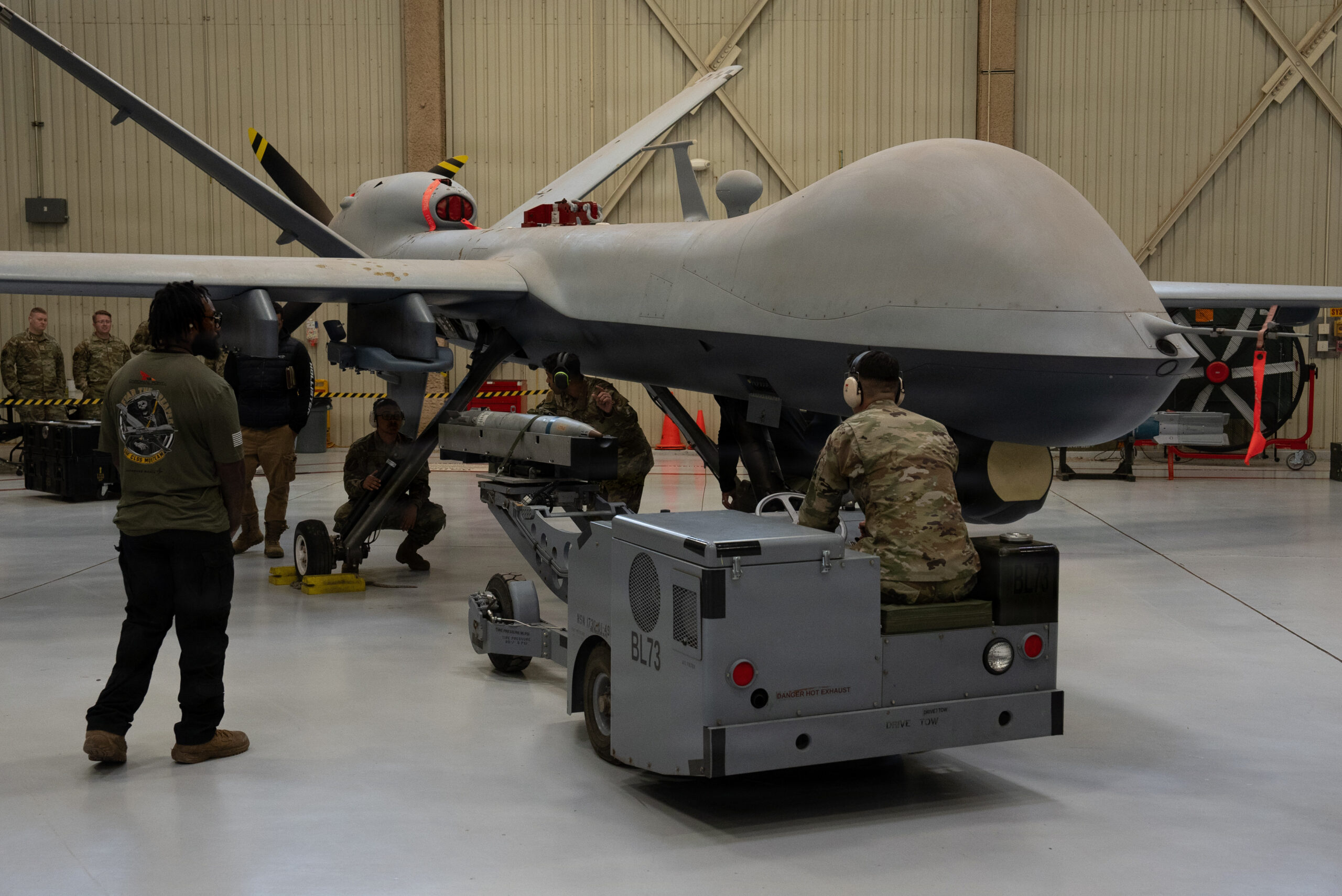 Air Commandos assigned to the 27th Special Operations Wing prepare to load a GBU-39B Small Diameter Bomb Weapon System onto an MQ-9 Reaper during a weapons load competition at Cannon Air Force Base, New Mexico, March 27, 2026. The GBU-39B is designed to limit collateral damage, expanding the MQ-9’s ability to deliver persistent, scalable effects in support of special operations forces across a range of operational environments. (U.S. Air Force photo by Staff Sgt. Kevin Williams)