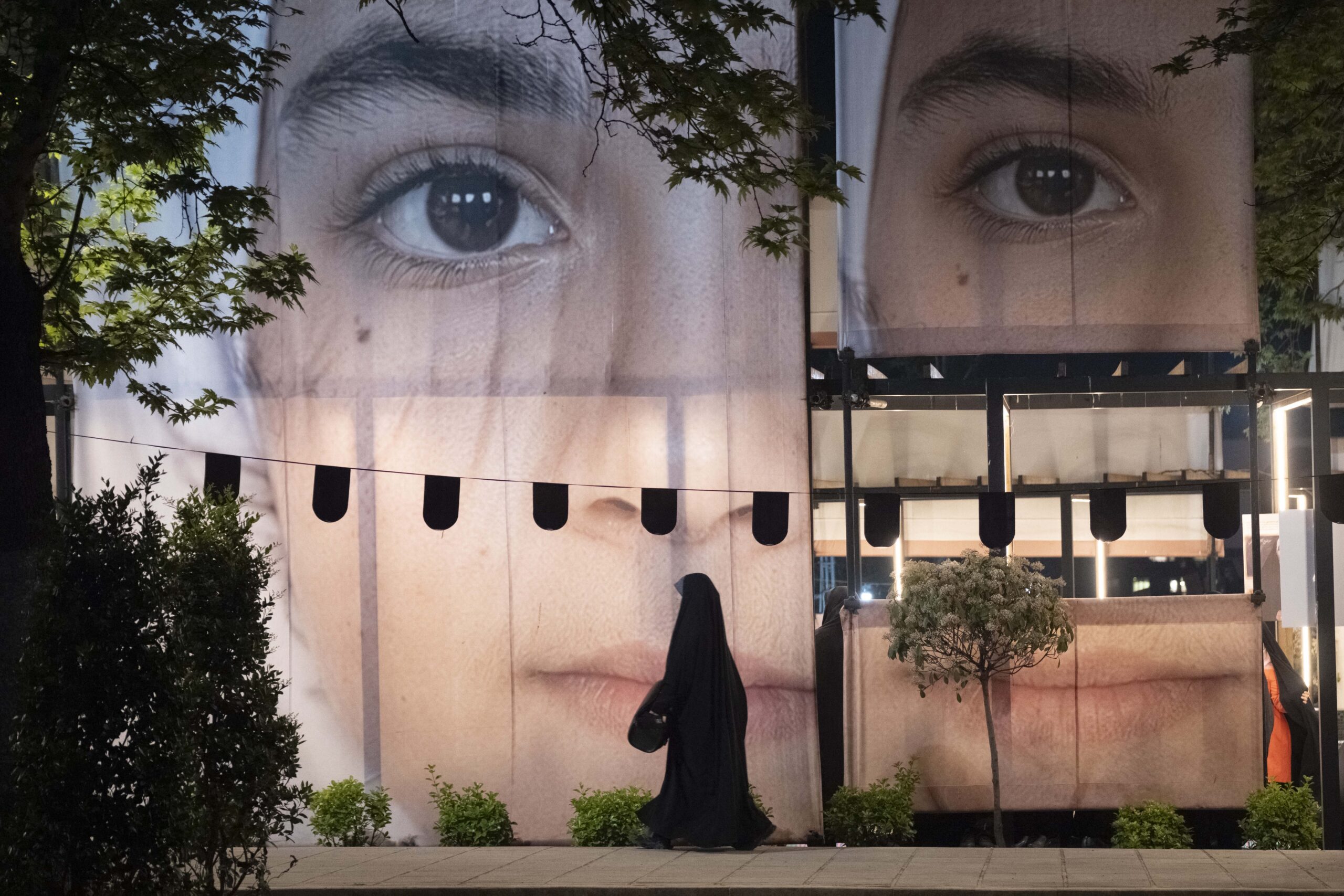 A banner depicting a portrait of a schoolgirl during a rally in northern Tehran, Iran, on May 2, 2026. The rally takes place as a ceasefire is extended