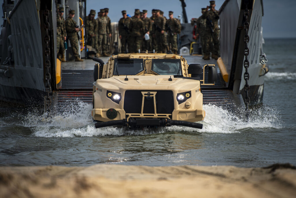 240724-N-OB471-1035 VIRGINIA BEACH (July 24, 2024) A Joint Light Tactical Vehicle (JLTV) exits a Landing Craft Utility (LCU) during Expeditionary Strike Group TWO’s (ESG 2) Defense Support to Civil Authorities (DSCA) full mission rehearsal exercise. Designed to integrate, embark, and bring ashore Navy and Marine Corps units that would be called upon to respond to a humanitarian disaster, the three-day exercise was conducted at various locations in the Hampton Roads, Virginia, area. As the U.S. Navy’s East Coast lead for amphibious operations and expertise, the staff of ESG 2 is postured to command or support operations in five separate combatant command areas of operations across the spectrum of conflict and competition, from humanitarian assistance to high-end combat. (U.S. Navy Photo by Mass Communication Specialist 2nd Class Jacob Hilgendorf)