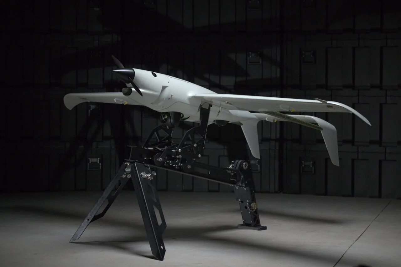 Skyeton Raybird fixed-wing reconnaissance UAV on a ground display stand, now upgraded with real-time anti-interceptor detection capability